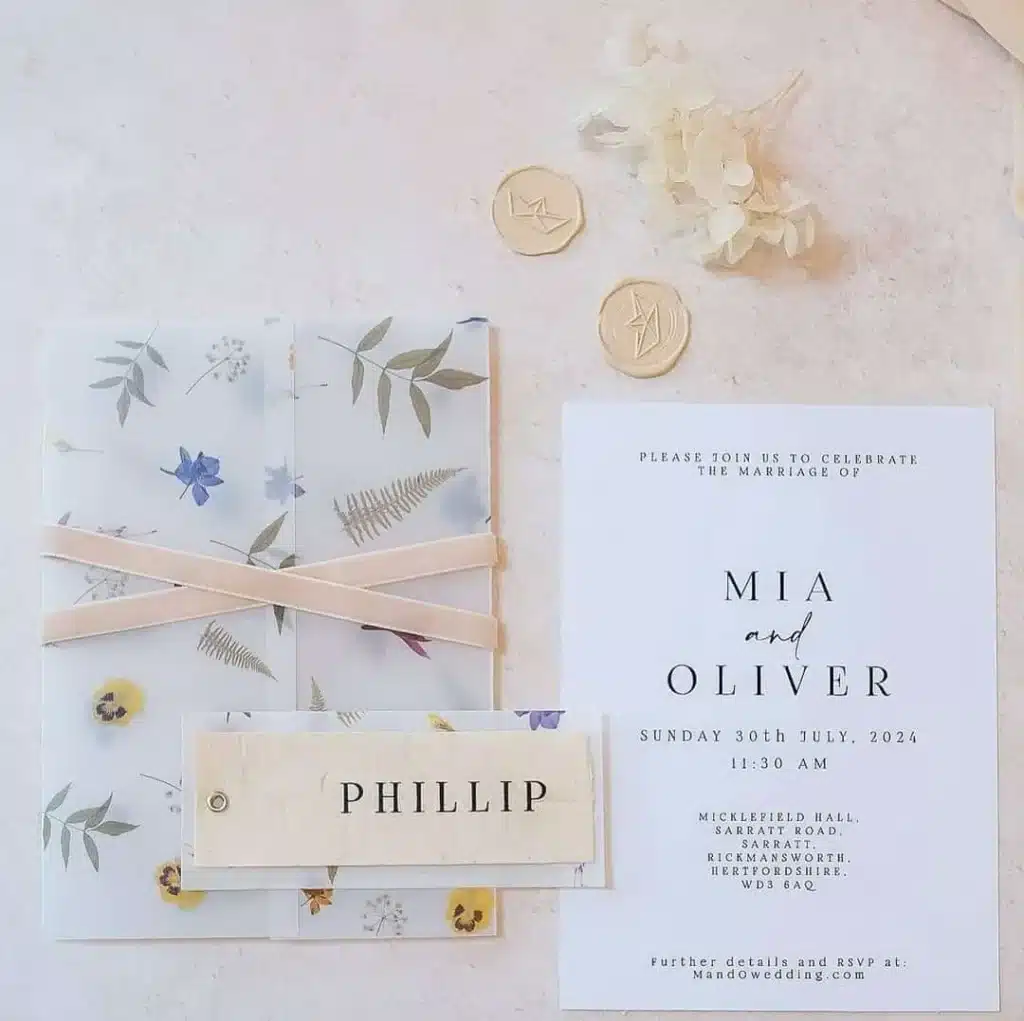 Custom wedding invitation set with floral details and wax seals.